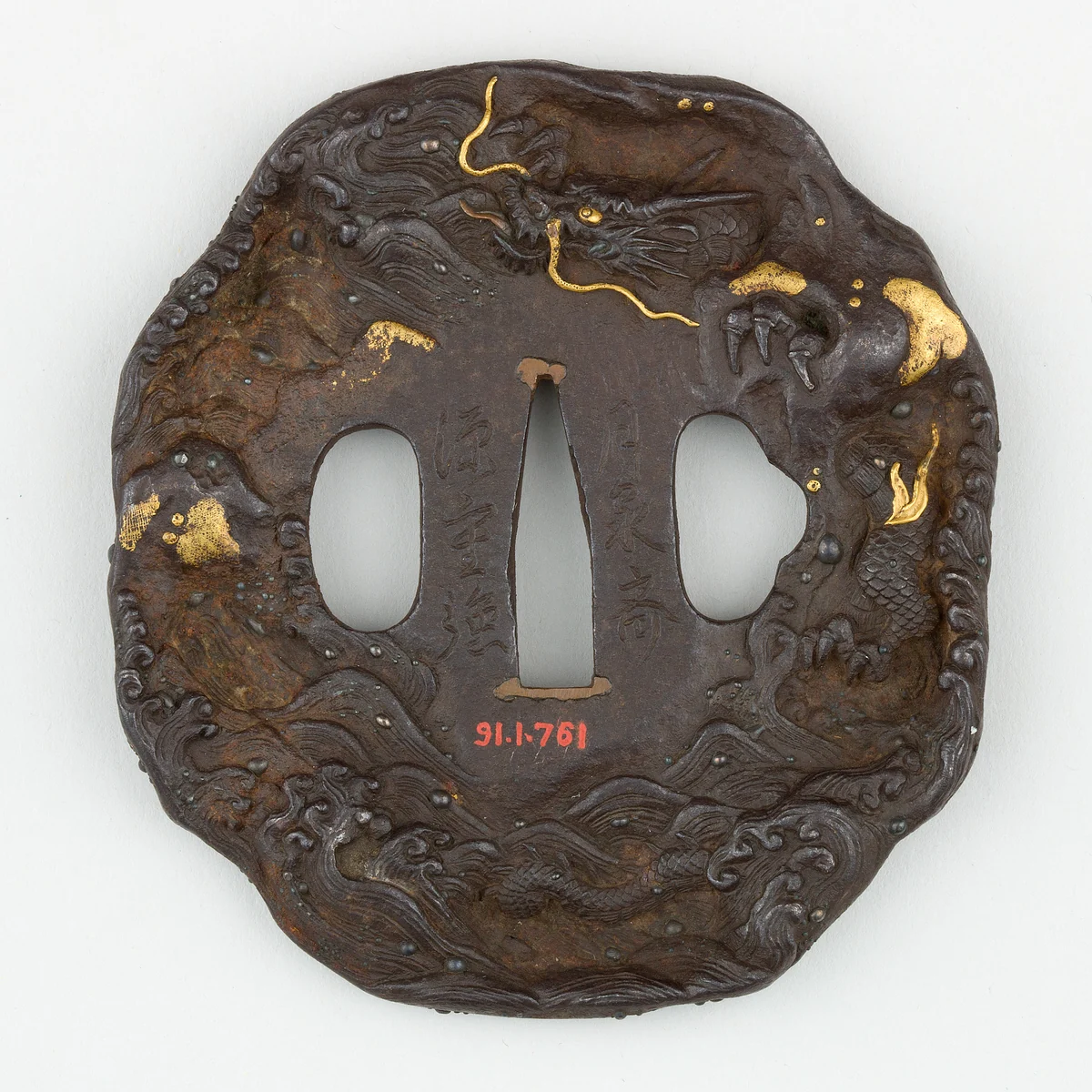 An iron sword guard worked with a dragon among waves